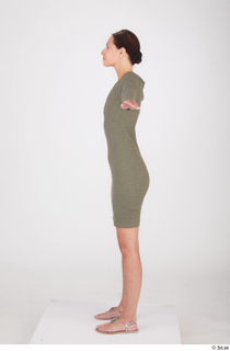 Vanessa Angel dressed green long sleeve dress standing t poses…